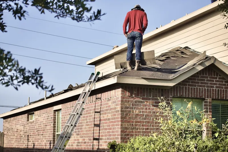 Professional roofer working on a residential roof in Deercreek